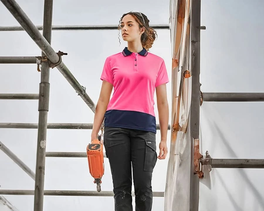 A woman wearing a Syzmik hi-vis short sleeve polo
