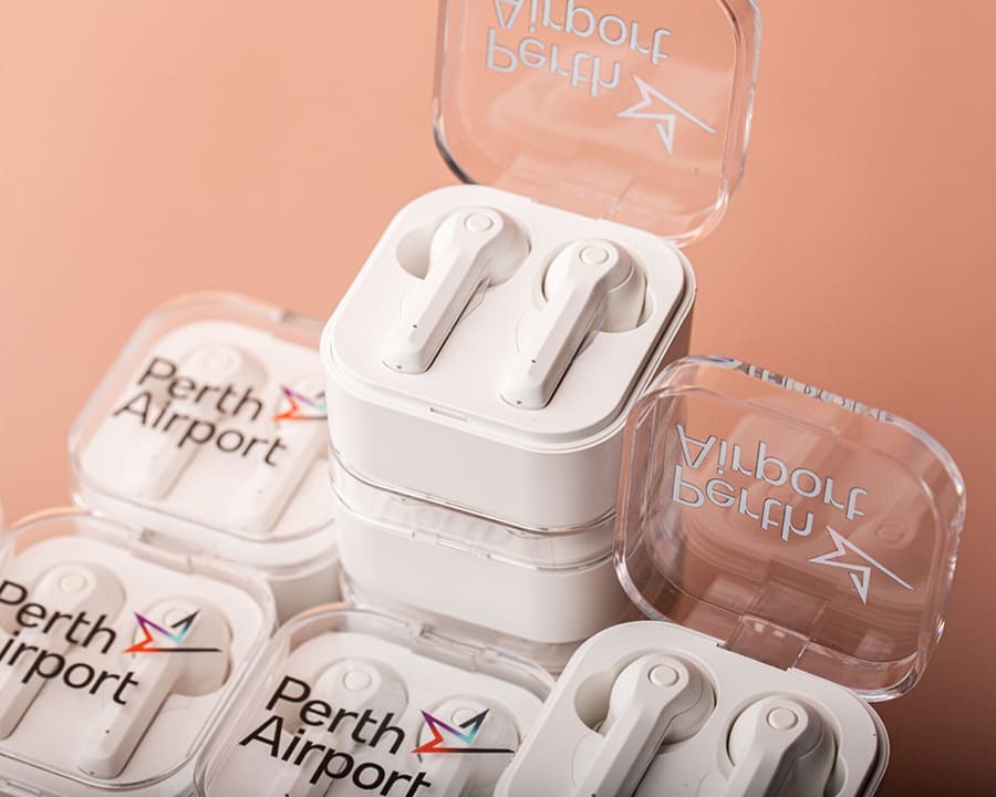 A stack of Perth Airport branded earbuds