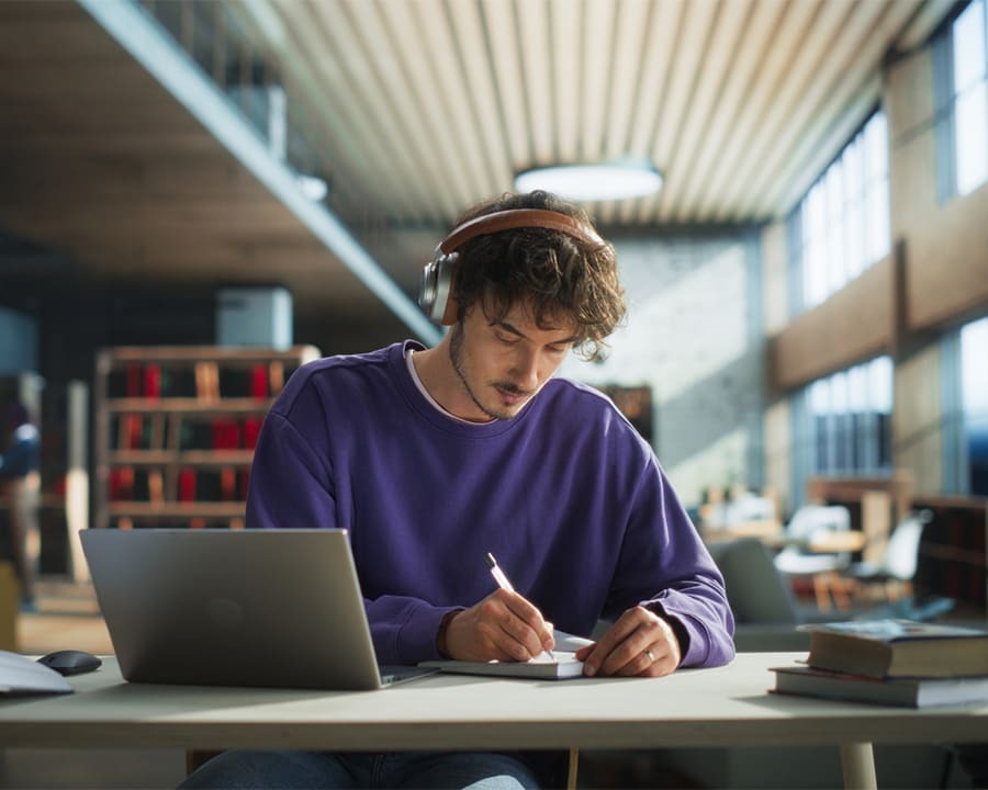 Young man studying in a library