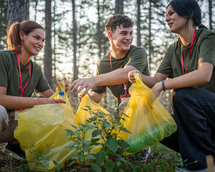 A group of young volunteer workers picking up litter