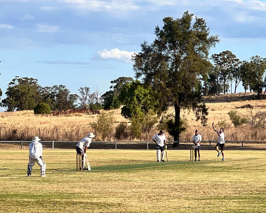 Group of men playing cricket together