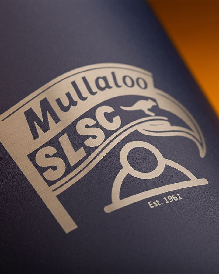 Close-up of engraved Mullaloo Surf Life Saving Club branding on a bottle