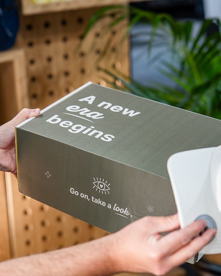 A person holding a Look Brilliant branded package