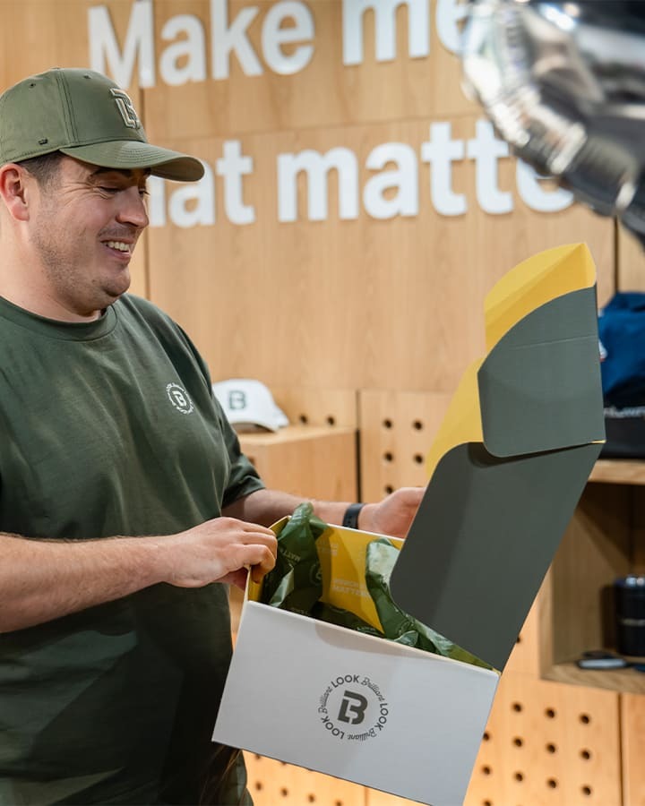 A Look Brilliant employee happily opening a box