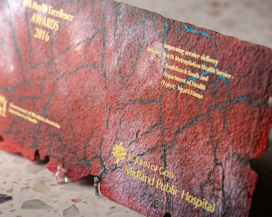 Close-up of a stone engraved St John of God award