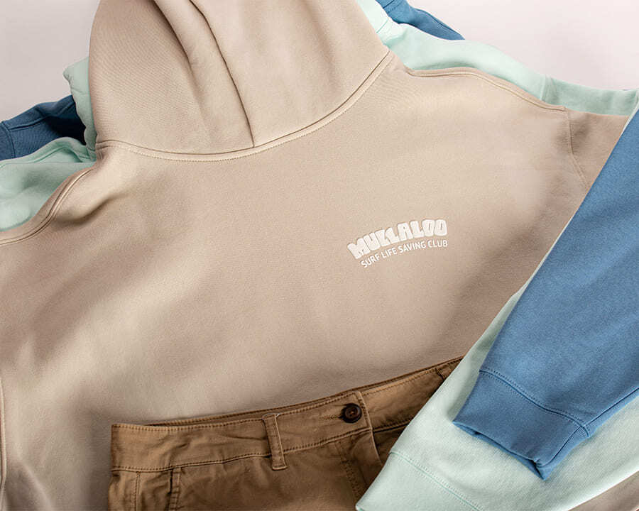 A stack of hoodies with Mullaloo Surf Life Saving branding