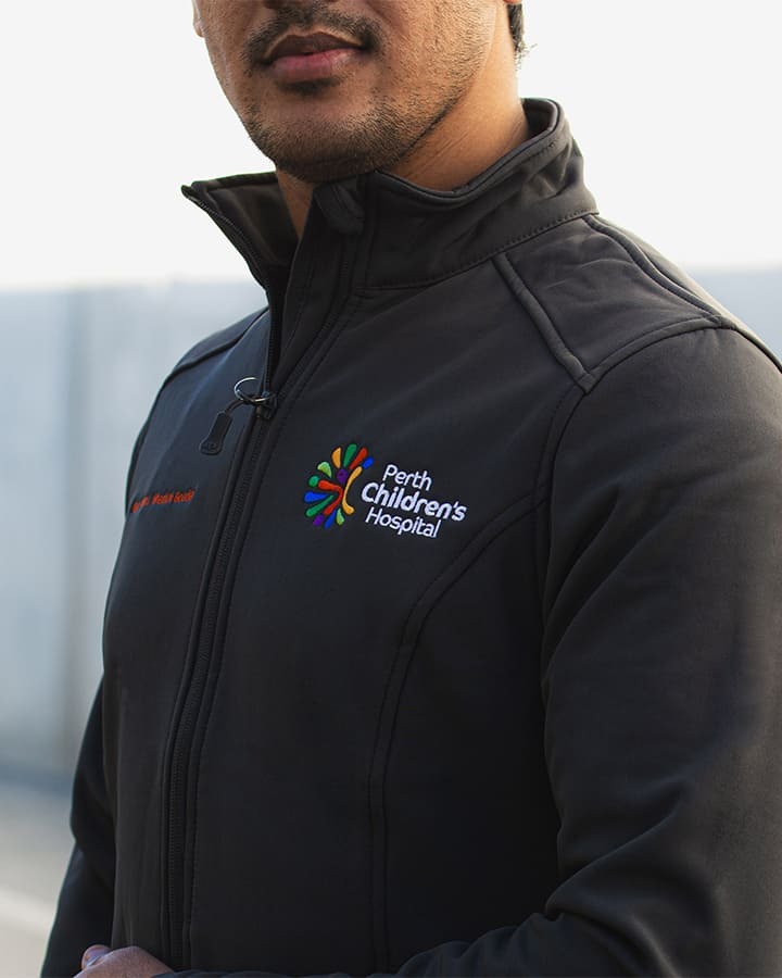 A man wearing a Perth Children's Hospital zipped jacket