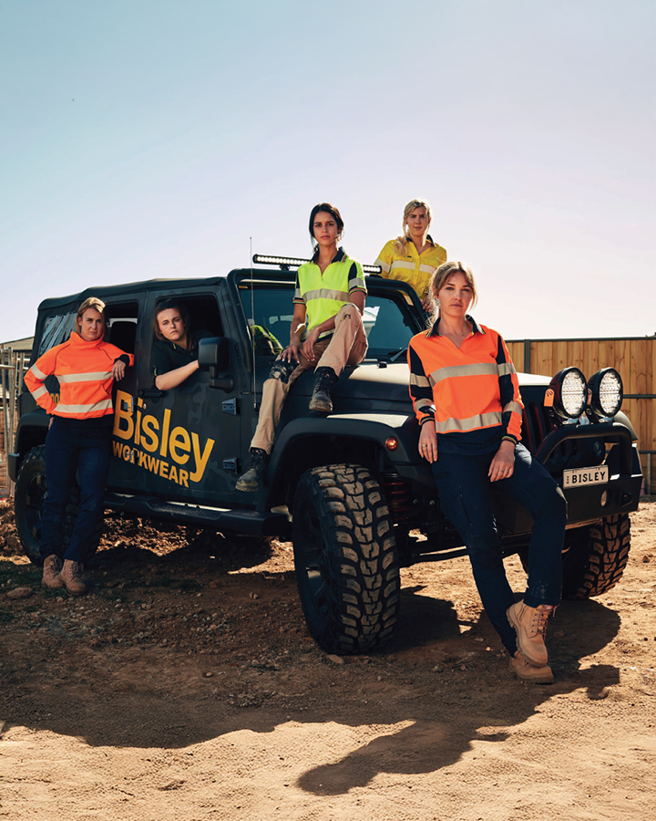 A group of female workers in high-visibility uniform