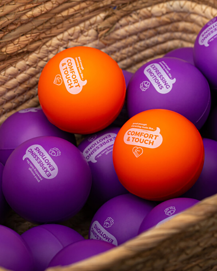 A basket of purple and orange stress balls