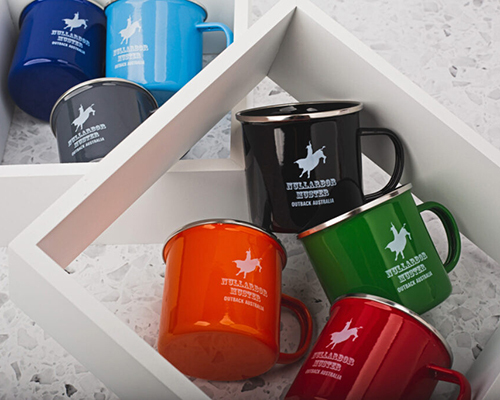 A collection of colourful mugs displayed in a white box