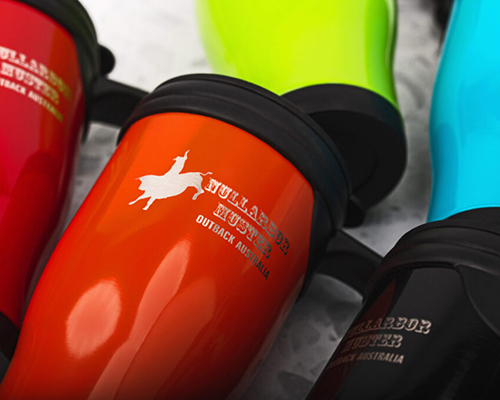 A close-up of colourful travel mugs