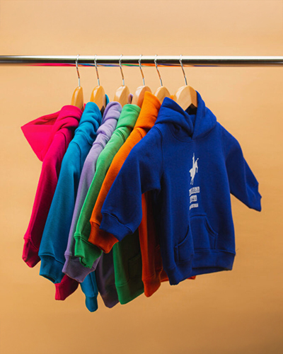 A row of colourful hoodies on a rack
