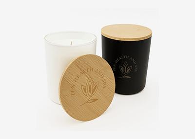 Two elegant candles, one white, the other black with wooden lids