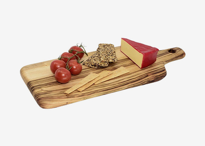 A wooden board with a wedge of cheese, cherry tomatoes on vine, crackers, and breadsticks