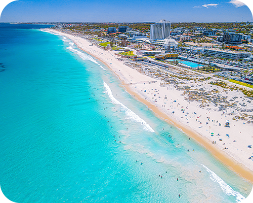 Aerial view of a vibrant beach with turquoise water and white sand
