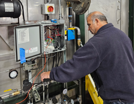 Horizon electrical engineer fine tunes the controls for a Cyclone Oven™.