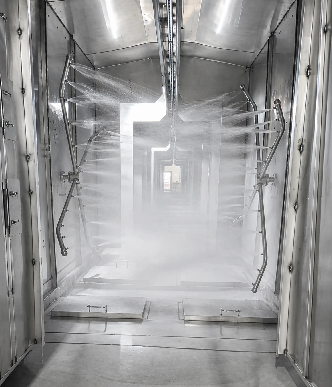 Interior of Horizon Torrent pretreatment washer showing rotating spray riser arms and nozzles
