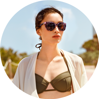 woman in swimsuit wearing sunglasses on beach