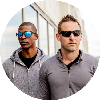 Two men outdoors wearing sport sunglasses