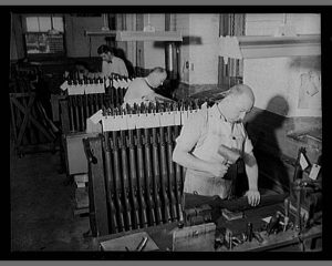 men at manufacturing benches doing final checks of the garands