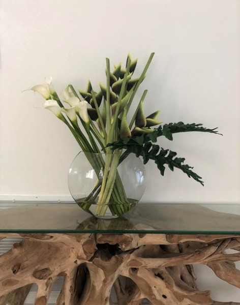 Moon vase with green Heliconias and Calla lilies