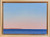 Small horizontal oil painting of a calm blue ocean under a pink and light blue pastel sunset sky by Grace Cooper.