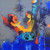 A large mixed-media canvas painting by Amol Pawar depicting a mother cradling a small orange Ganesha against a blue and gray background, with birds.