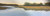 "Awaken" original 12x36 panoramic pastel painting by Sandra Kavanaugh showing a wide tidal river reflecting a pale dawn sky next to golden marsh grass and a white farmhouse