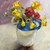 Square impressionist oil painting of yellow daffodils and red flowers in a blue and white ceramic jug by Sara Rae.