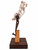 Vertical three-quarter view of contemporary mixed media sculpture 'Back in the Saddle' featuring a pink and white red raspberry alabaster stone balanced on a rustic iron hinge on a walnut base by Rebecca Robinson.