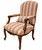 Vintage Italian Rococo Revival walnut fauteuil armchair upholstered in a red and gold striped fabric with a matching lumbar pillow on an isolated white background