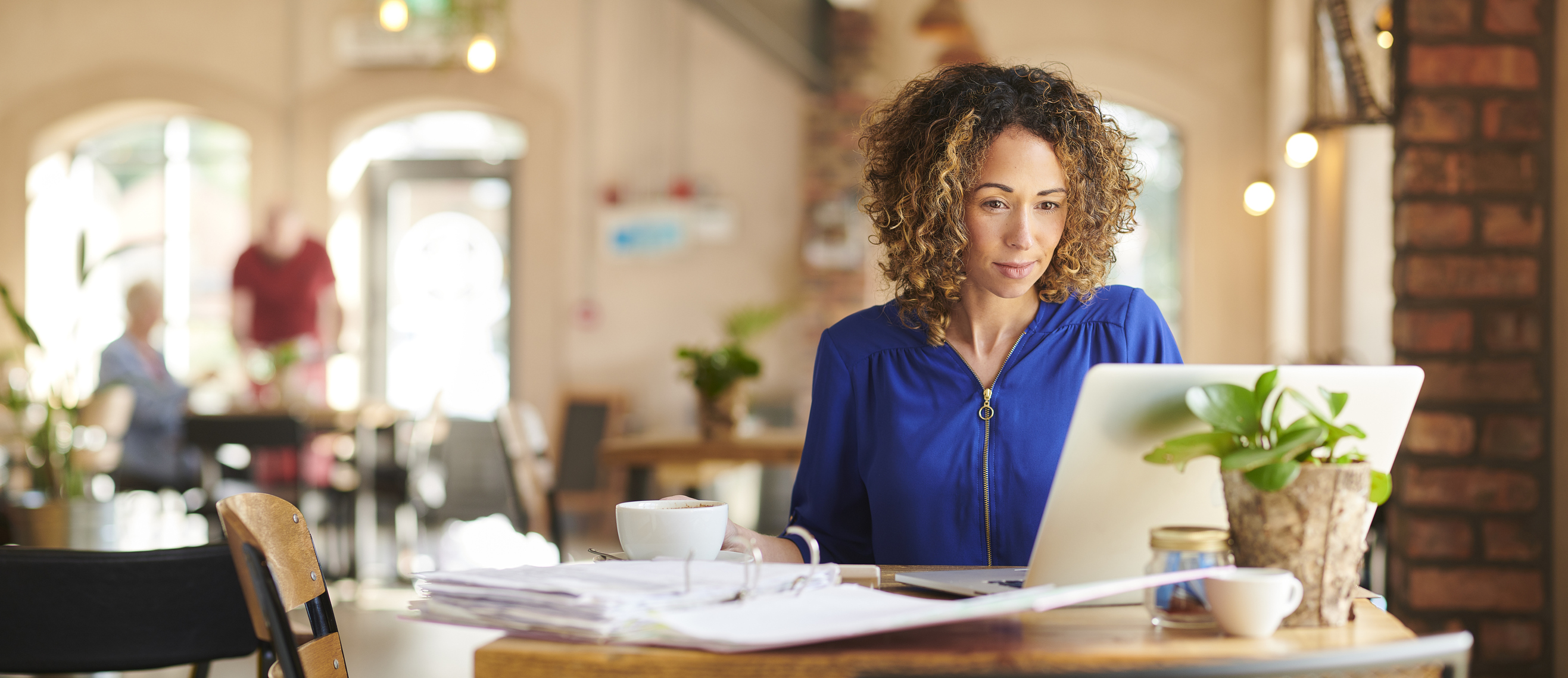 Woman on a computer drinking coffee