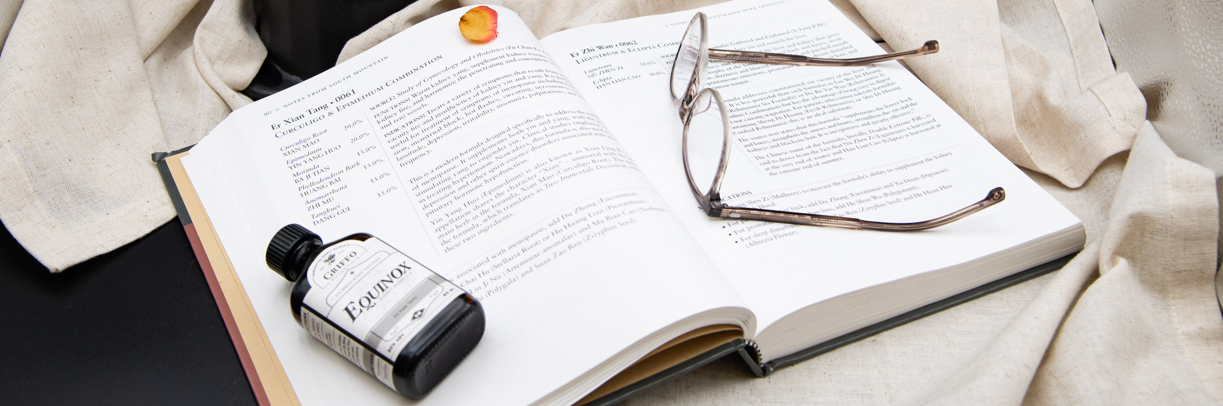 Equinox Tincture laying on a textbook