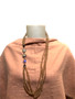 mannequin wearing pink scarf and necklace