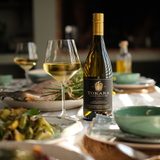 A bottle of tokara reserve chardonnay on a table of food