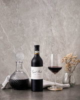 Bottle of Fairview 'Cyril Back' Shiraz, Coastal Region 2017, red wine with notes of blackberry, plum, spice and oak. Bottle of wine next to glass of red wine and decanter.