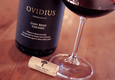 Bottle of Stony Brook Vineyards 'Ovidius' Tempranillo, Franschhoek 2020 red wine with dark fruit and spice. Bottle of wine next to glass of red wine and cork.