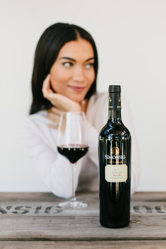 Woman drinking a glass of Bottle of Simonsig Merindol Syrah 2018 from Stellenbosch, South Africa