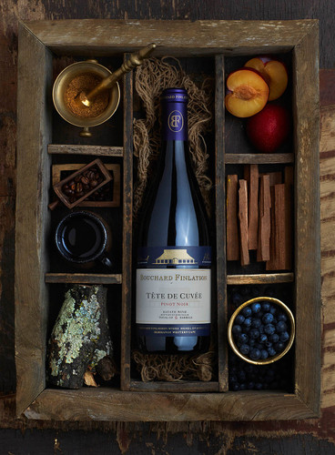 Bottle of Bouchard Finlayson 'Tête de Cuvée' Pinot Noir, Walker Bay 2021, Cape South Coast wine with strawberry, cinnamon, black cherry, rose, and spiced oak notes. Bottle of wine in box surrounded by tasting note elements.