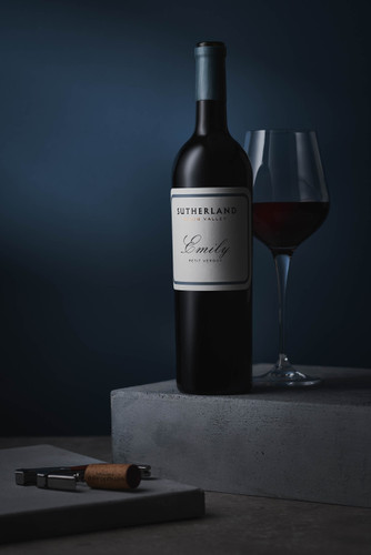 Bottle of Thelema 'Sutherland Emily' Petit Verdot, Elgin 2021 red wine with dark fruit and spice. Bottle of wine next to glass of red wine.