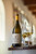 Bottle of La Motte Chardonnay, Franschhoek 2022 white wine with citrus and oak. Bottle of wine next to glasses of white wine.