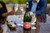 Bottle of Steenberg Sparkling Sauvignon Blanc, Constantia NV sparkling wine with tropical and citrus notes. People sitting at table with bottle of sparkling wines next to glasses of sparkling wine.
