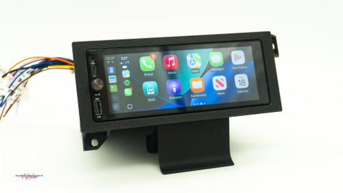 Aftermarket 1.5-DIN touchscreen radio mounted in a custom dash kit for a 1994â€“2002 Dodge Ram