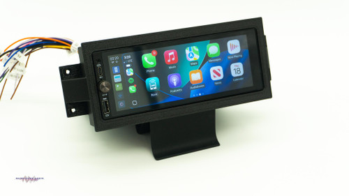 Aftermarket 1.5-DIN touchscreen radio mounted in a custom dash kit for a 1984â€“1989 Chevrolet Corvette (C4)