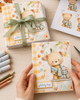 Pre-coloured printable clipart of a cute teddy bear sharing an aqua checked scarf with a little mouse friend, softly illustrated in a watercolour style from the Polkadoodles Hello Autumn collection.