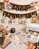 Cute bear and mouse pumpkin car Halloween black and white digital stamp featuring woodland animals riding in a jack-o'-lantern pumpkin vehicle with bat steering wheel, hanging dice and pumpkin wheels.