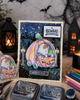 Cute bear and mouse pumpkin car Halloween black and white digital stamp featuring woodland animals riding in a jack-o'-lantern pumpkin vehicle with bat steering wheel, hanging dice and pumpkin wheels.