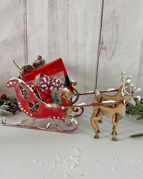 MDF 3D Santa's Reindeer Sleigh MDF blank Craft Kit – Christmas Holiday Home Décor crafts, decorated with holiday ornaments and placed on a festive table.