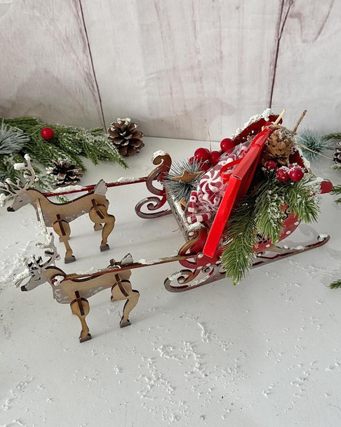 MDF 3D Santa's Reindeer Sleigh MDF blank Craft Kit – Christmas Holiday Home Décor crafts, decorated with holiday greenery, pinecones, and red berries, ideal for festive holiday decoration.