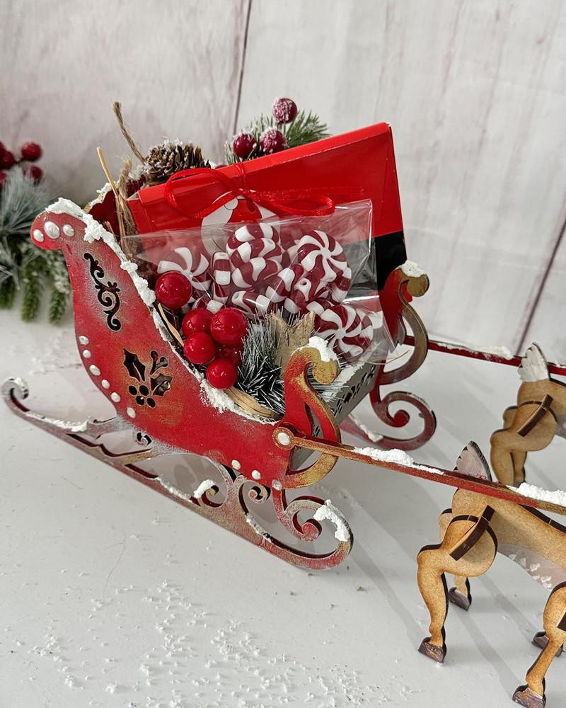 MDF 3D Santa's Reindeer Sleigh MDF blank Craft Kit – Christmas Holiday Home Décor crafts, festive red and white holiday sleigh with candy, berries, and pine cone decorations.